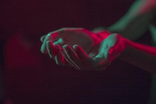 Woman holding her hands out to form a cup. 